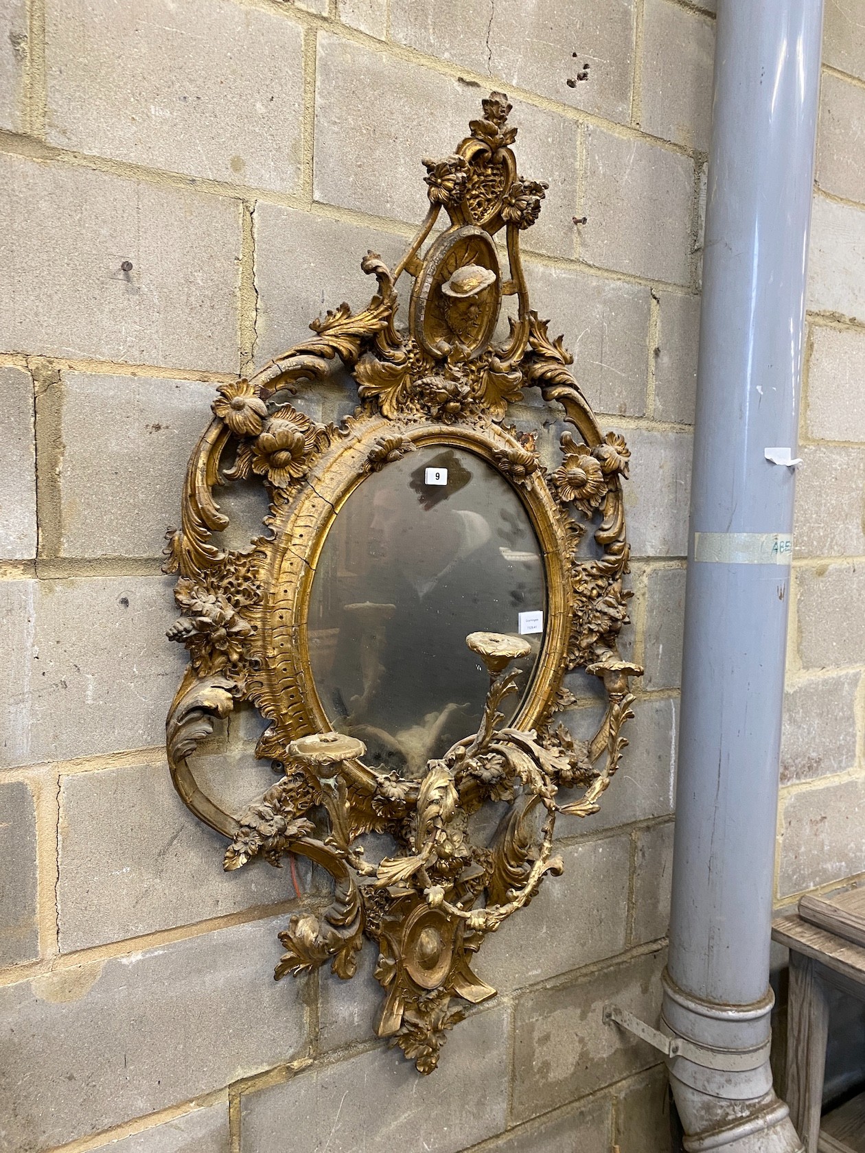 A Victorian carved giltwood and composition girandole, with three candle arms, mirror width 74cm, height 132cm